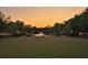 Picturesque pond view at sunset with walking paths and benches for residents at 482 Oak View Way, Summerville, SC 29483