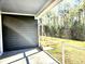 A screened porch offers an outdoor living space with views of the backyard and surrounding trees at 482 Oak View Way, Summerville, SC 29483