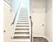 Wooden staircase featuring white trim and doors at 482 Oak View Way, Summerville, SC 29483