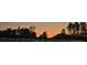 Sunset view over water separated by a white fence, lined with trees at 482 Oak View Way, Summerville, SC 29483