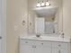 Bathroom with vanity, cabinets, sink, a large mirror, and lighting fixture at 4913 Lake Palmetto Ln, North Charleston, SC 29418