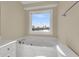 Clean bathroom with a bathtub offering a view of the water outside at 4913 Lake Palmetto Ln, North Charleston, SC 29418