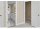 Bright bathroom featuring a white vanity and walk in closet with built in shelving at 4913 Lake Palmetto Ln, North Charleston, SC 29418
