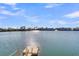 Clear lake view with blue skies, a small dock, and distant buildings are a beautiful sight at 4913 Lake Palmetto Ln, North Charleston, SC 29418