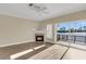 Cozy living room with a fireplace, sliding glass doors to the deck, and waterfront views at 4913 Lake Palmetto Ln, North Charleston, SC 29418