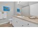 Clean bathroom features a vanity with ample counter space, white cabinets, and decorative wall art at 500 Bucksley Ln # 308, Charleston, SC 29492