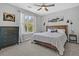 Comfortable bedroom features a wooden headboard bed, dark dresser, and bright natural light from large window at 500 Bucksley Ln # 308, Charleston, SC 29492