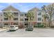 Condominium complex exterior with palm trees and manicured landscaping at 500 Bucksley Ln # 308, Charleston, SC 29492