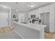 Open concept kitchen with stainless steel appliances, white cabinets and large island with pendant lighting at 500 Bucksley Ln # 308, Charleston, SC 29492