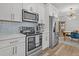Well-equipped kitchen showcasing stainless steel appliances, white cabinetry, and a stylish backsplash at 500 Bucksley Ln # 308, Charleston, SC 29492