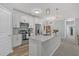 Bright kitchen with white cabinets, stainless steel appliances, and a large center island with quartz countertops at 500 Bucksley Ln # 308, Charleston, SC 29492