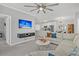 Relaxing living room with large TV, comfortable sofa, and open view into a modern kitchen and dining area at 500 Bucksley Ln # 308, Charleston, SC 29492
