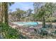 Community pool surrounded by lounge chairs and lush landscaping at 500 Bucksley Ln # 308, Charleston, SC 29492