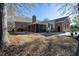 Home's backyard features a brick house, patio, and lawn with mature trees at 5367 Boone Run, Hollywood, SC 29449