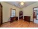 Bedroom featuring a hardwood floor, window shutters, and adjacent room at 5367 Boone Run, Hollywood, SC 29449