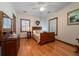 Charming bedroom with hardwood floors, bright windows, and a cozy bed at 5367 Boone Run, Hollywood, SC 29449