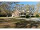 Charming brick home with a long front porch, columns, dormers, and a circular driveway surrounded by trees at 5367 Boone Run, Hollywood, SC 29449