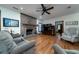 Cozy living room with a brick fireplace, hardwood floors, comfortable seating and natural light at 5367 Boone Run, Hollywood, SC 29449
