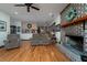 Inviting living room featuring a brick fireplace, hardwood floors, comfortable furniture and access to the kitchen at 5367 Boone Run, Hollywood, SC 29449