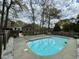 Backyard featuring a pool, surrounded by white rock, and a wooden fence at 5367 Boone Run, Hollywood, SC 29449
