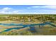 Expansive aerial view of waterfront homes with private docks and lush greenery at 5758 Chisolm Rd, Johns Island, SC 29455