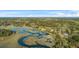 Breathtaking aerial view of a waterfront property with a long private pier extending into the tranquil marsh and waterway at 5758 Chisolm Rd, Johns Island, SC 29455