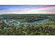 Gorgeous aerial view features meandering waterways through marshland with a beautiful sunset sky above at 5758 Chisolm Rd, Johns Island, SC 29455