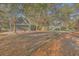 Large backyard featuring a guest house, mature trees and grass, a grill and seating area at 5758 Chisolm Rd, Johns Island, SC 29455