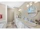 Elegant bathroom with dual vanity sinks, a separate soaking tub, and neutral tones at 5758 Chisolm Rd, Johns Island, SC 29455