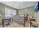 This bedroom features a comfortable bed, desk, and plenty of natural light from the window at 5758 Chisolm Rd, Johns Island, SC 29455