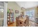 Inviting dining room with hardwood floors, stylish light fixture, and easy access to the outdoors at 5758 Chisolm Rd, Johns Island, SC 29455