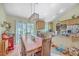 Open dining area with hardwood floors, modern lighting, and access to the kitchen and backyard at 5758 Chisolm Rd, Johns Island, SC 29455