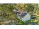 Aerial view of a house surrounded by trees and lush vegetation in a serene setting at 5758 Chisolm Rd, Johns Island, SC 29455