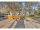 Lovely home featuring a wooden deck, mature trees, and a well-maintained gravel driveway at 5758 Chisolm Rd, Johns Island, SC 29455