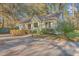 Quaint single-story home with a welcoming front porch and mature trees in a peaceful setting at 5758 Chisolm Rd, Johns Island, SC 29455