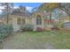 Attractive home featuring lush landscaping, colorful floral accents, and a well-maintained lawn at 5758 Chisolm Rd, Johns Island, SC 29455