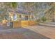 Beautiful home featuring a wooden deck and gravel driveway, surrounded by lush trees at 5758 Chisolm Rd, Johns Island, SC 29455