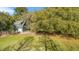 Aerial view of a gray home with white trim surrounded by mature trees at 5758 Chisolm Rd, Johns Island, SC 29455