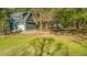 Charming home exterior with lush green lawn and cozy outdoor sitting area at 5758 Chisolm Rd, Johns Island, SC 29455