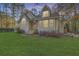 Charming exterior with lush lawn, blossoming flowers, and an American flag displayed at 5758 Chisolm Rd, Johns Island, SC 29455