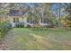 Quaint yellow home featuring a charming front porch, lush landscaping, and a welcoming exterior at 5758 Chisolm Rd, Johns Island, SC 29455