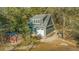 Detached garage with living space above, red shed, and gravel, offering additional parking at 5758 Chisolm Rd, Johns Island, SC 29455