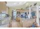 Bright kitchen boasting granite countertops, wooden cabinetry, and an island with bar seating at 5758 Chisolm Rd, Johns Island, SC 29455