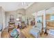 Spacious living room connected to dining area and kitchen, featuring hardwood floors and neutral tones at 5758 Chisolm Rd, Johns Island, SC 29455