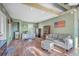 Spacious living room with hardwood floors, comfortable sofa, and well-lit office area at 5758 Chisolm Rd, Johns Island, SC 29455