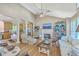 Open-concept living room with hardwood floors, fireplace, decorative columns, and kitchen view at 5758 Chisolm Rd, Johns Island, SC 29455