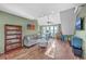 Bright living room with hardwood floors, comfortable seating, and natural light at 5758 Chisolm Rd, Johns Island, SC 29455