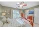 Sunlit main bedroom features a decorative ceiling fan, coordinated wooden furniture and a view at 5758 Chisolm Rd, Johns Island, SC 29455