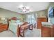 Well-lit main bedroom featuring a decorative ceiling fan, and coordinated wooden furniture at 5758 Chisolm Rd, Johns Island, SC 29455