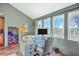 Bright home office with three windows, a modern desk setup, and beautiful views at 5758 Chisolm Rd, Johns Island, SC 29455